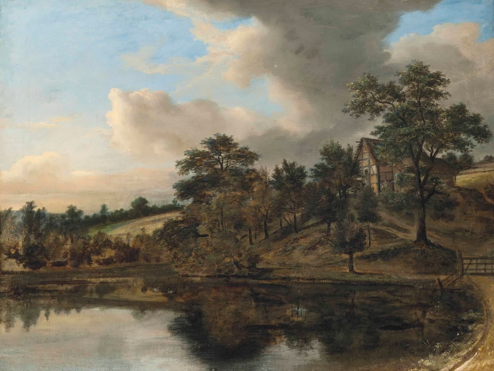 Bosrijk landschap met een huisje aan een meer
